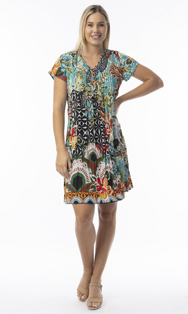 Woman wearing a colorful patterned dress on a white background