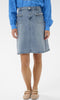 Person wearing a blue denim skirt and blue sweater on a white background