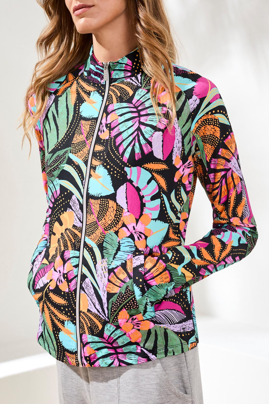 Colorful butterfly patterned jacket worn by a person on a white background
