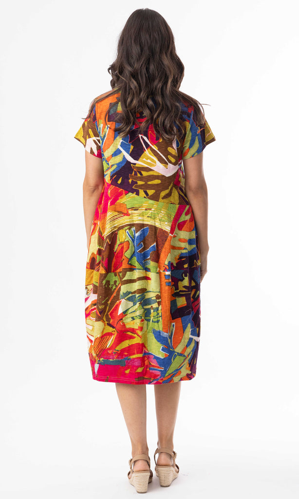 Woman wearing a colorful dress with a pattern on a white background