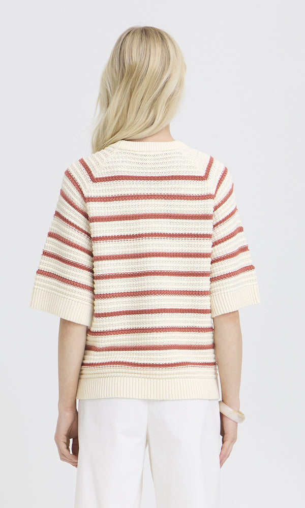 Person wearing a striped sweater with short sleeves on a white background