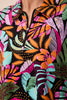Colorful patterned fabric with tropical leaf design on a black background