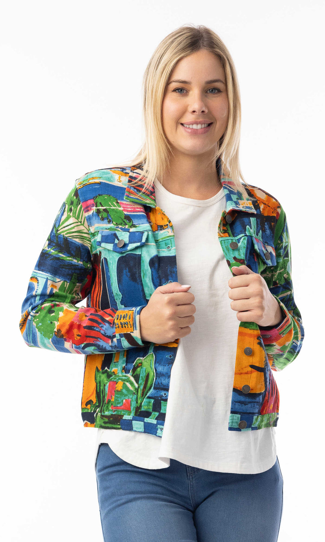 Woman wearing a colorful jacket with a white shirt and blue jeans on a white background
