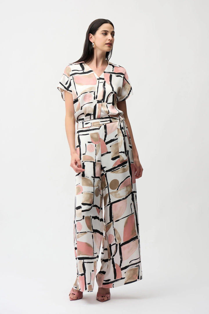 Woman wearing a patterned jumpsuit on a white background