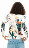 Abstract floral art print lightweight long sleeve knit sweater with crew neckline and ribbed trim styled with denim.