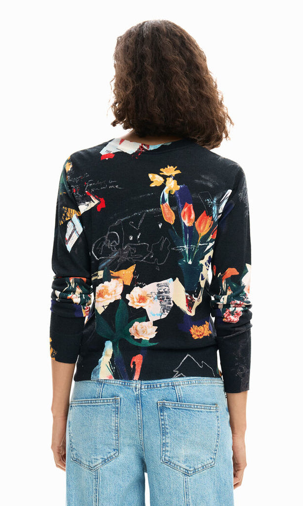 Abstract floral art print lightweight long sleeve knit sweater with crew neckline and ribbed trim styled with denim.