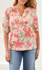 Floral split neck blouse with puff sleeves and relaxed fit styled with denim