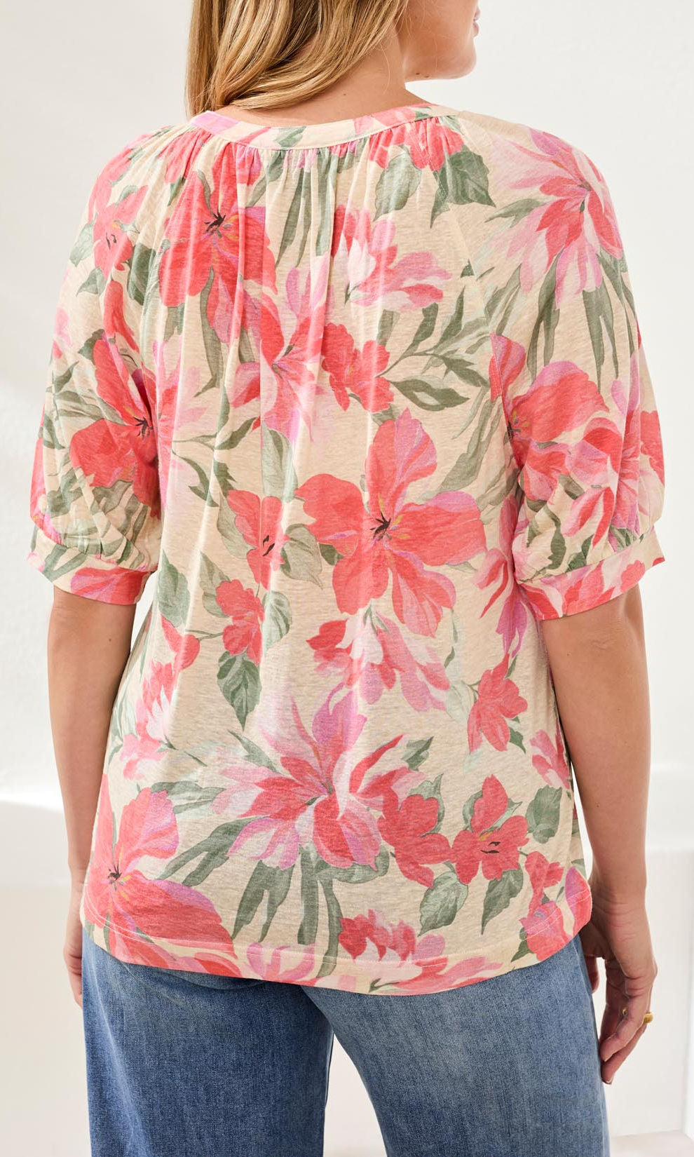 Floral split neck blouse with puff sleeves and relaxed fit styled with denim
