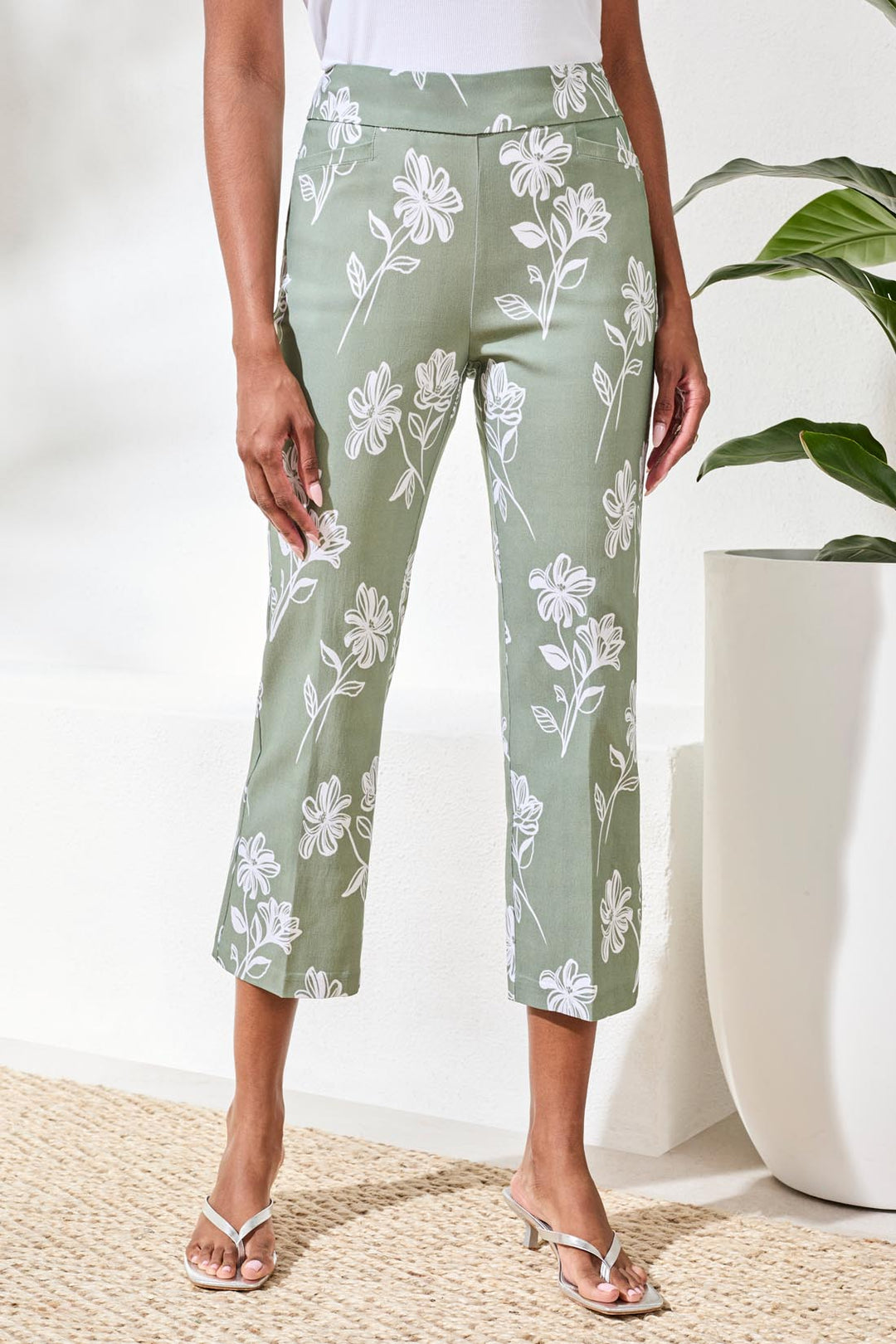 Floral print cropped straight leg high rise pull-on ankle pants with streamlined silhouette.