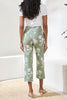 Floral print cropped straight leg high rise pull-on ankle pants with streamlined silhouette.