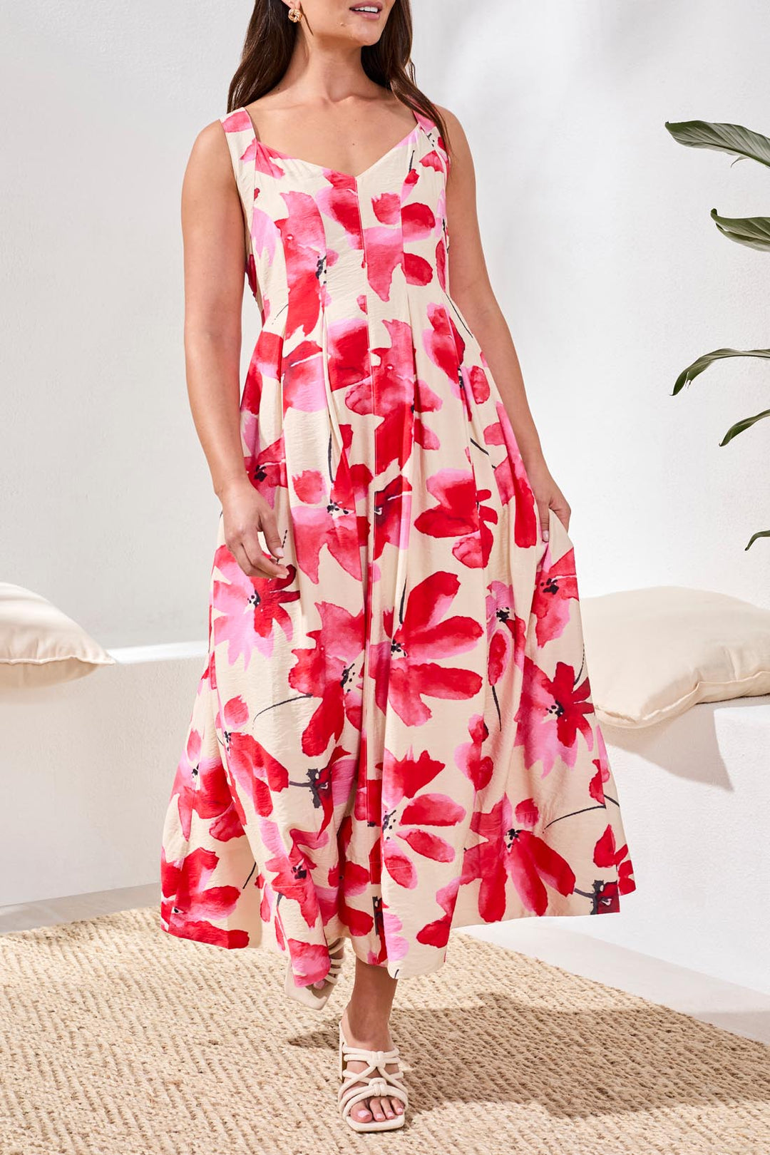 Woman wearing a red floral dress in a home setting