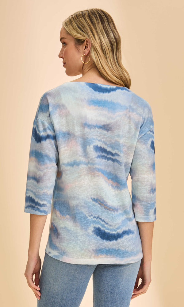 Blue neutral tie-dye knit 3/4 sleeve V-neck top worn with light denim