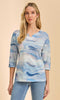 Blue neutral tie-dye knit 3/4 sleeve V-neck top worn with light denim