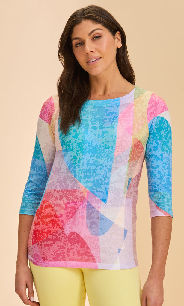 Woman wearing a colorful patterned top with a beige background