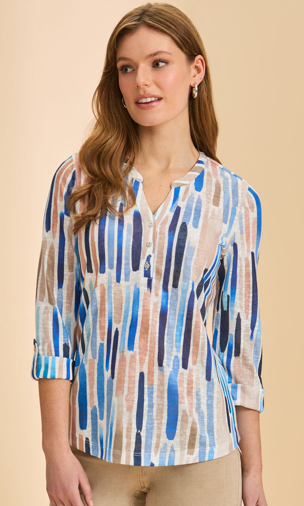 Woman wearing a patterned blouse with blue and brown stripes on a beige background