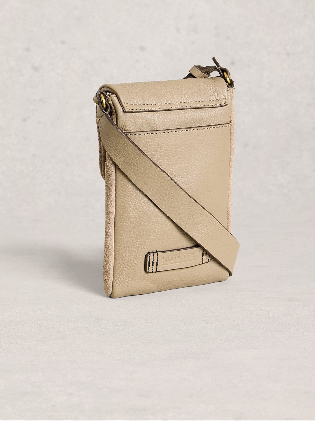 Beige crossbody bag on a light gray background