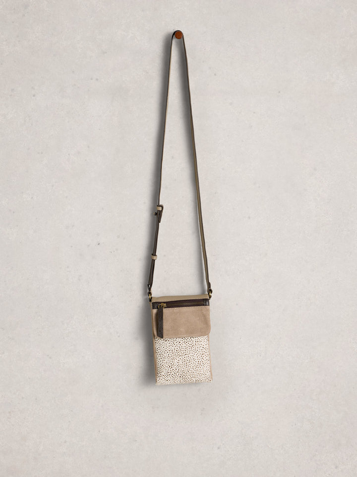 Small crossbody bag with textured surface on a light gray background