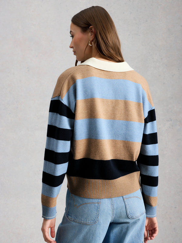 Person wearing a striped sweater with a neutral background
