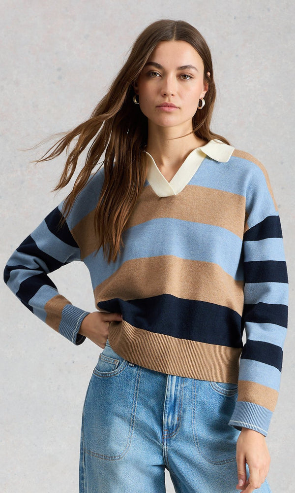 Woman wearing a striped sweater with a plain background