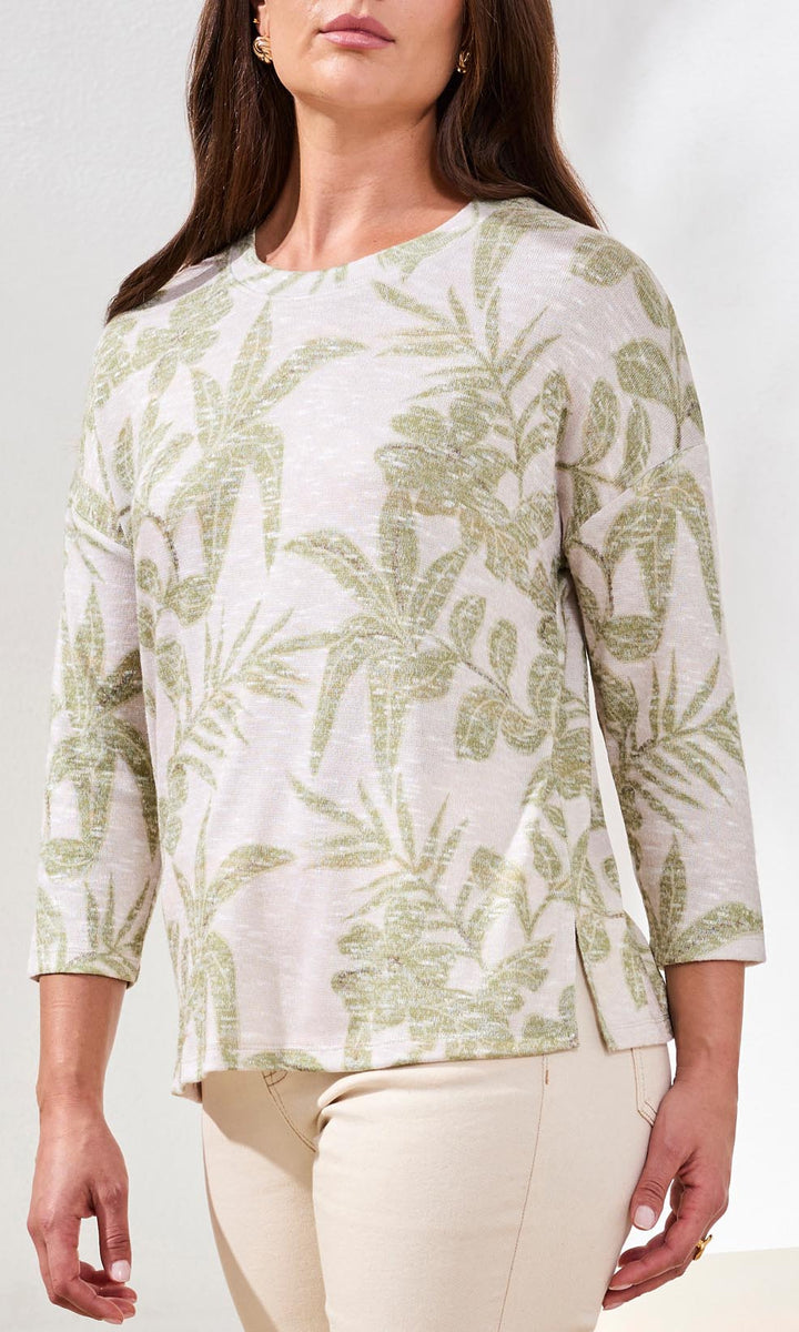 Tropical botanical print 3/4 sleeve lightweight knit top with crew neckline and side slits.