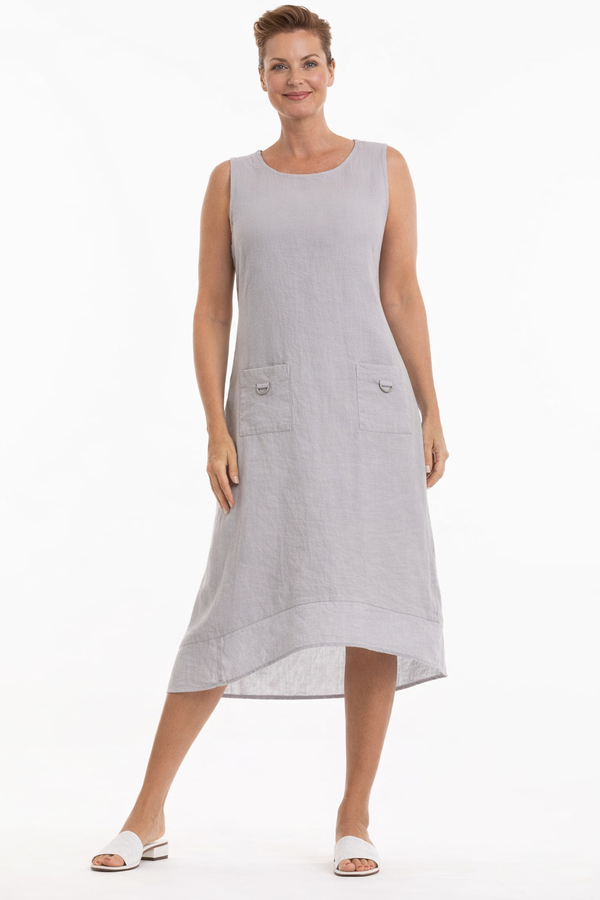 Woman wearing a light gray sleeveless dress on a white background