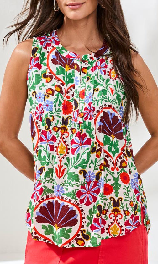 Woman wearing a colorful floral sleeveless top with a white background