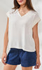 V-neck cap sleeve lightweight relaxed fit blouse with soft drape styled with denim shorts.