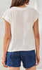 V-neck cap sleeve lightweight relaxed fit blouse with soft drape styled with denim shorts.
