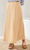 Beige skirt worn by a person on a neutral background