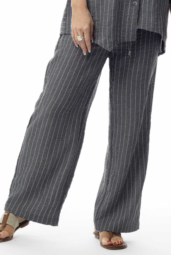 Pinstripe pants worn by a person on a white background