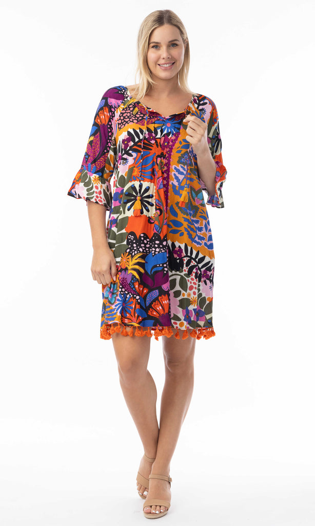 Woman wearing a colorful patterned dress on a white background