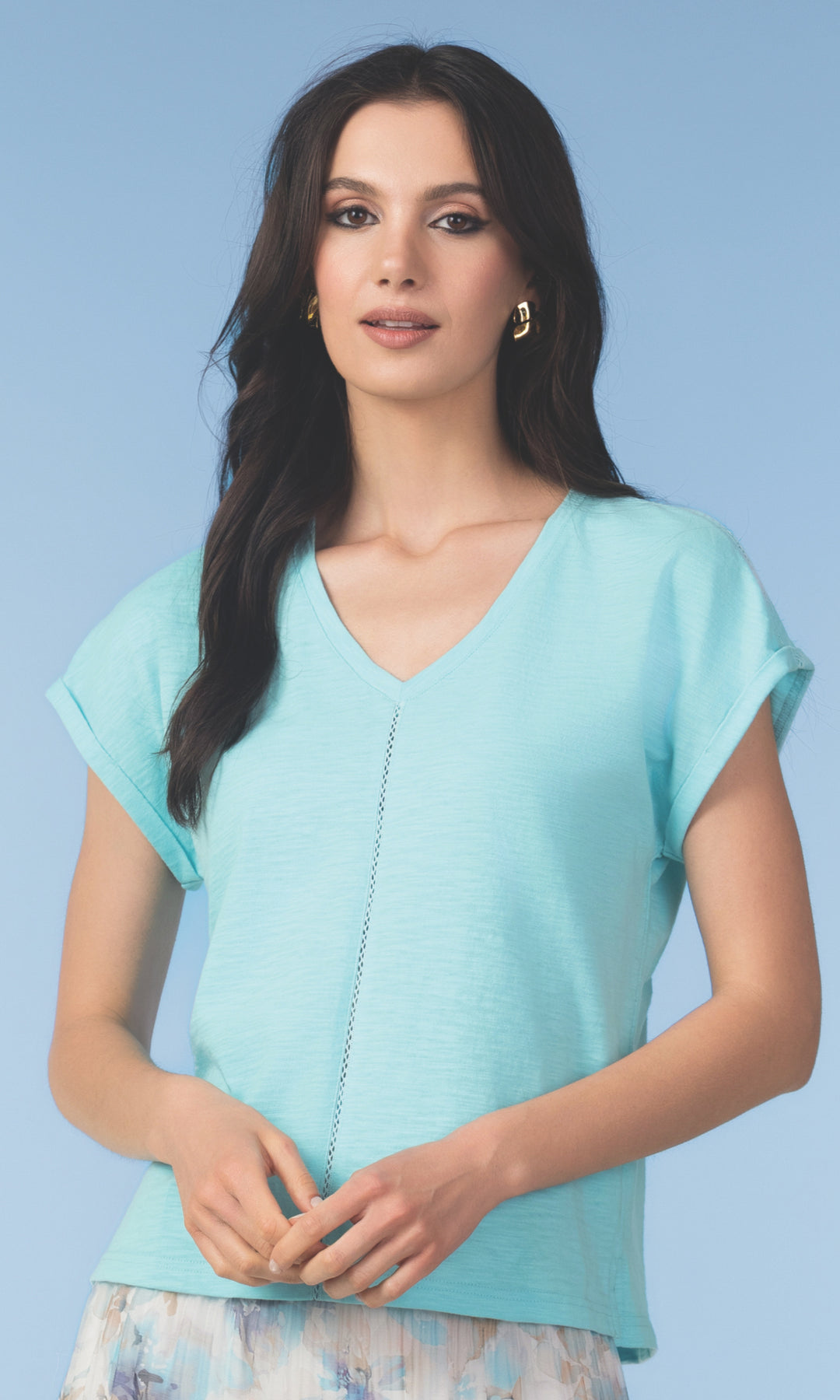 Woman wearing a light blue top against a light blue background