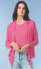 Woman wearing a pink cardigan over a pink top with light blue jeans on a light blue background