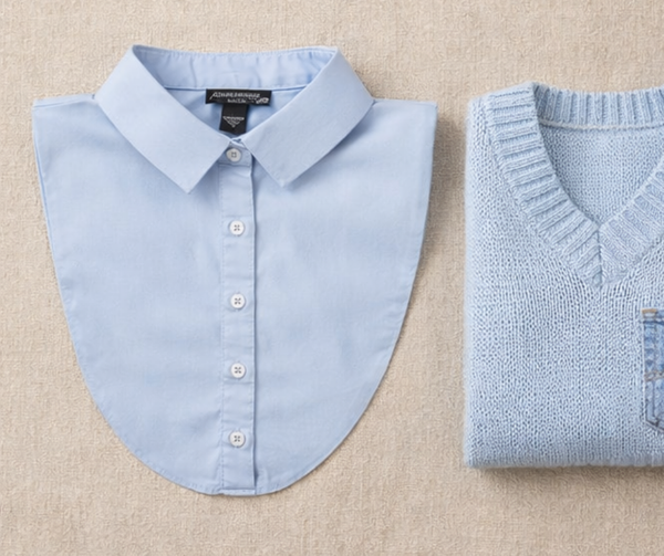 Light blue shirt and sweater on a beige background