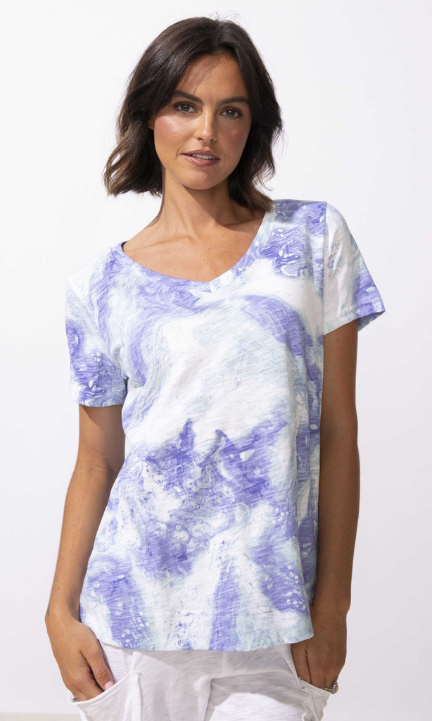 Abstract print V-neck short sleeve top with relaxed fit and lightweight fabric.