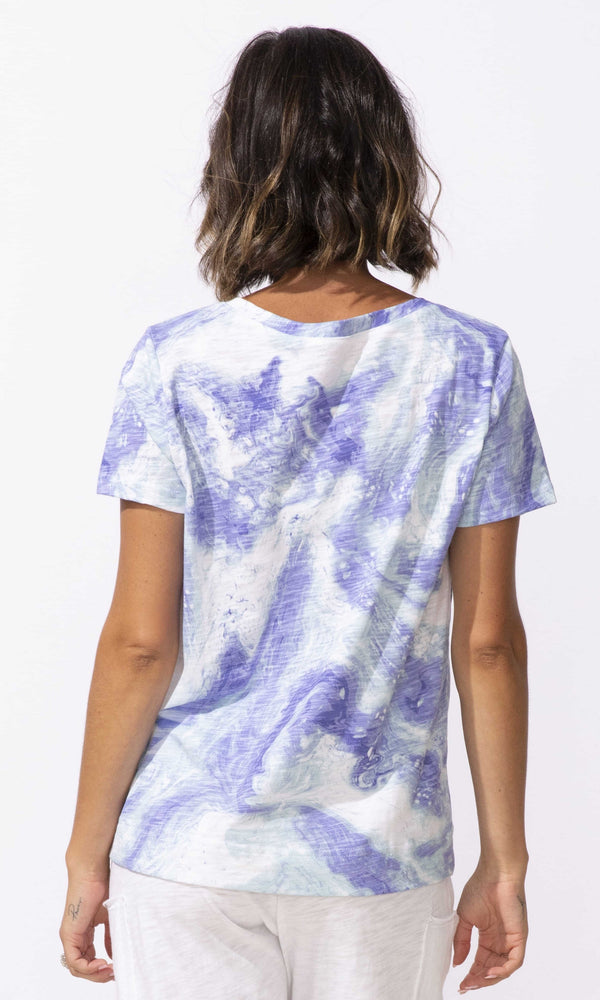 Abstract print V-neck short sleeve top with relaxed fit and lightweight fabric.