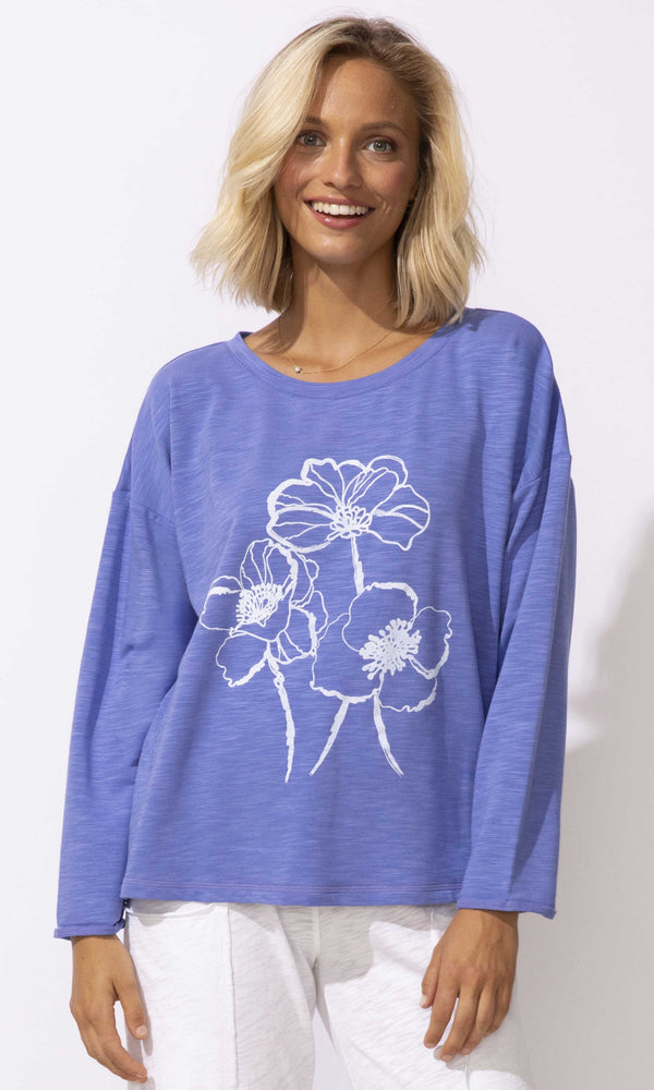 Floral graphic long sleeve relaxed fit pullover top with crew neckline.