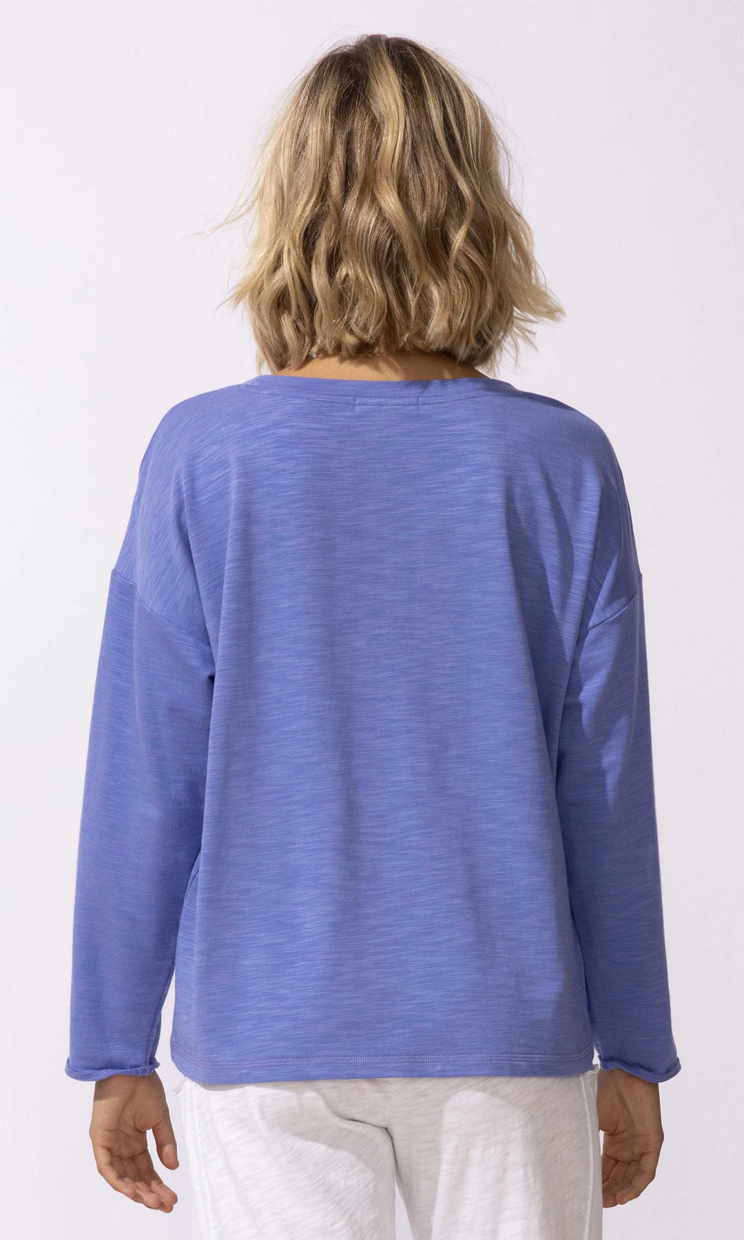 Floral graphic long sleeve relaxed fit pullover top with crew neckline.