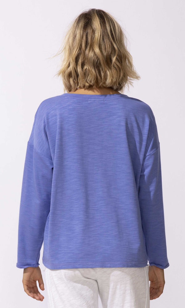 Floral graphic long sleeve relaxed fit pullover top with crew neckline.