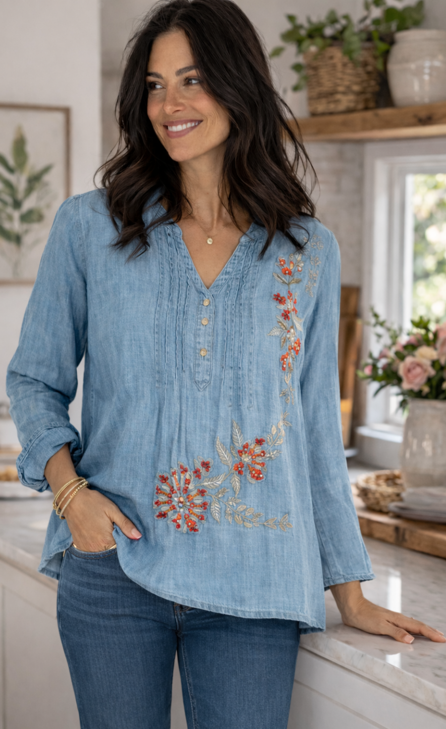Woman wearing a blue embroidered blouse in a kitchen setting