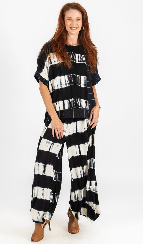 Woman wearing a black and white striped outfit on a white background