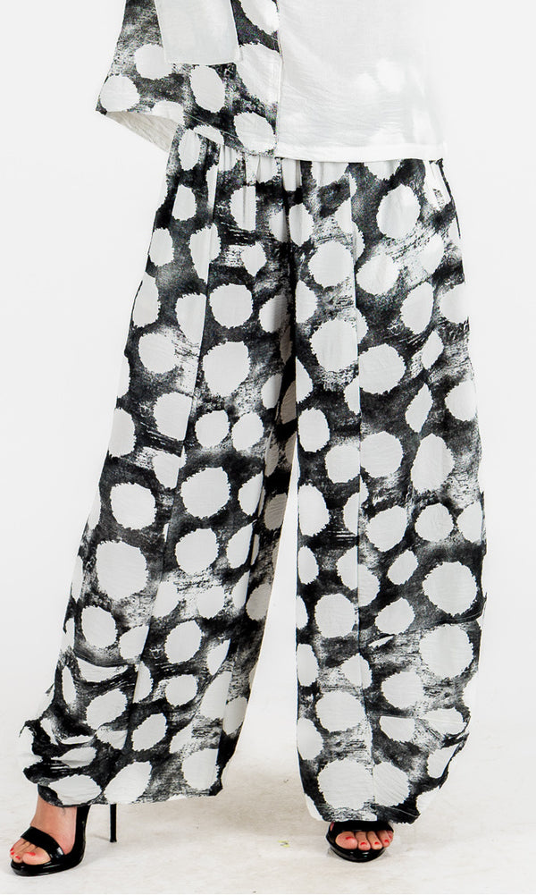 Black and white patterned pants worn by a person on a white background