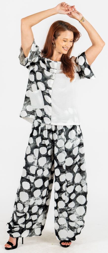 Woman wearing a black and white patterned outfit on a white background