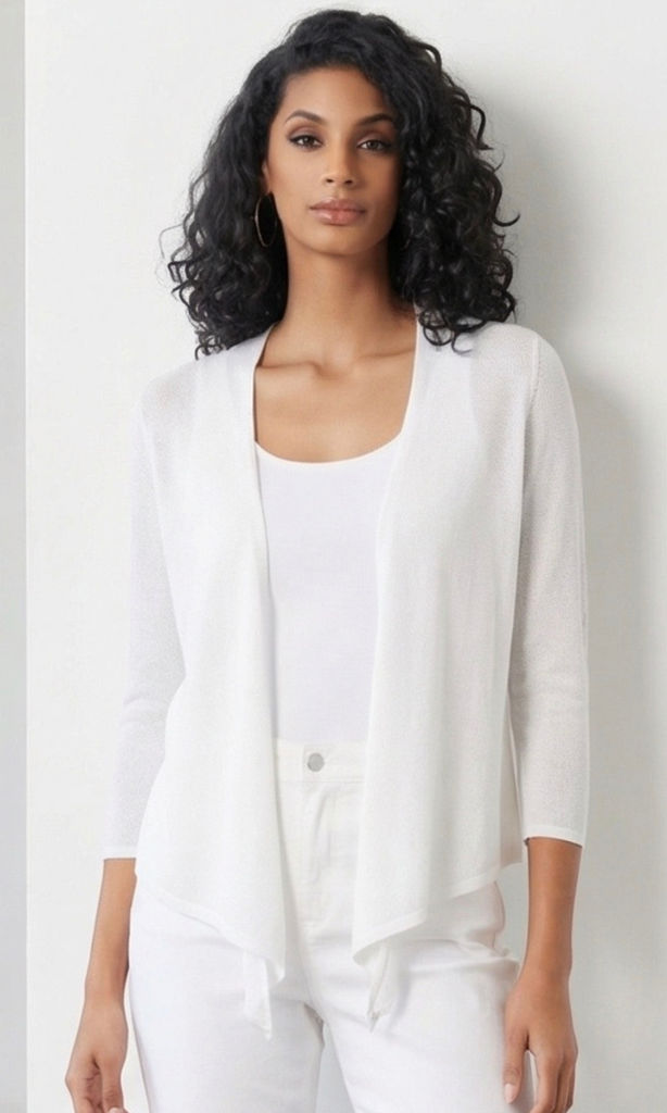 Woman wearing a white cardigan over a white top against a plain background