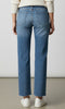 Model wearing high rise straight leg denim jeans with raw hem and classic five pocket styling.