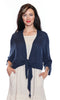 Woman wearing a navy blue cardigan over a white dress on a white background