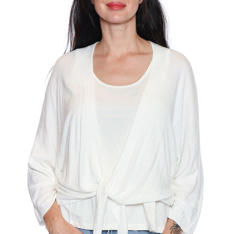 Woman wearing a white blouse with a tie front design on a white background