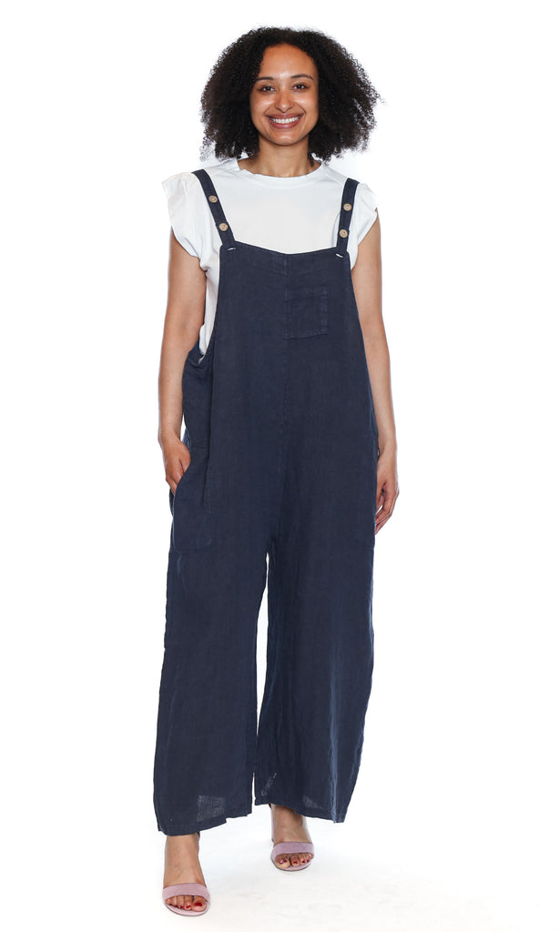Woman wearing navy blue overalls on a white background