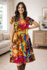 Woman wearing a colorful dress in a living room setting