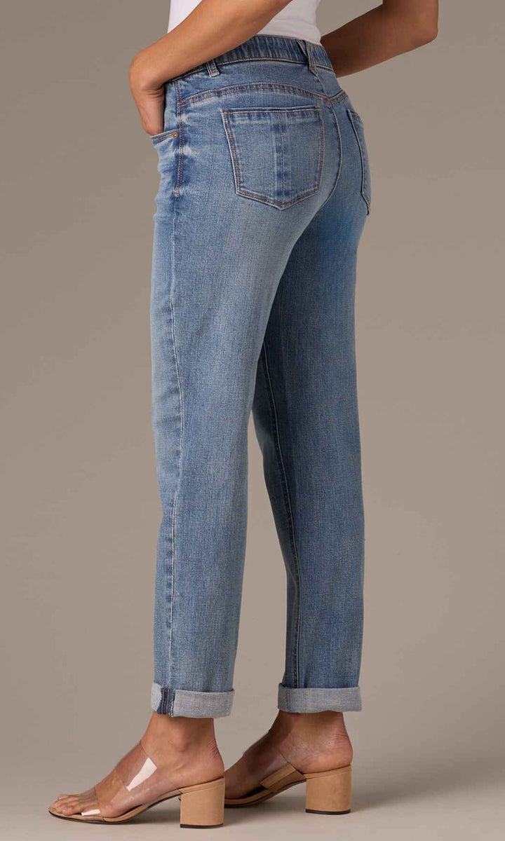Blue jeans worn by a person on a neutral background